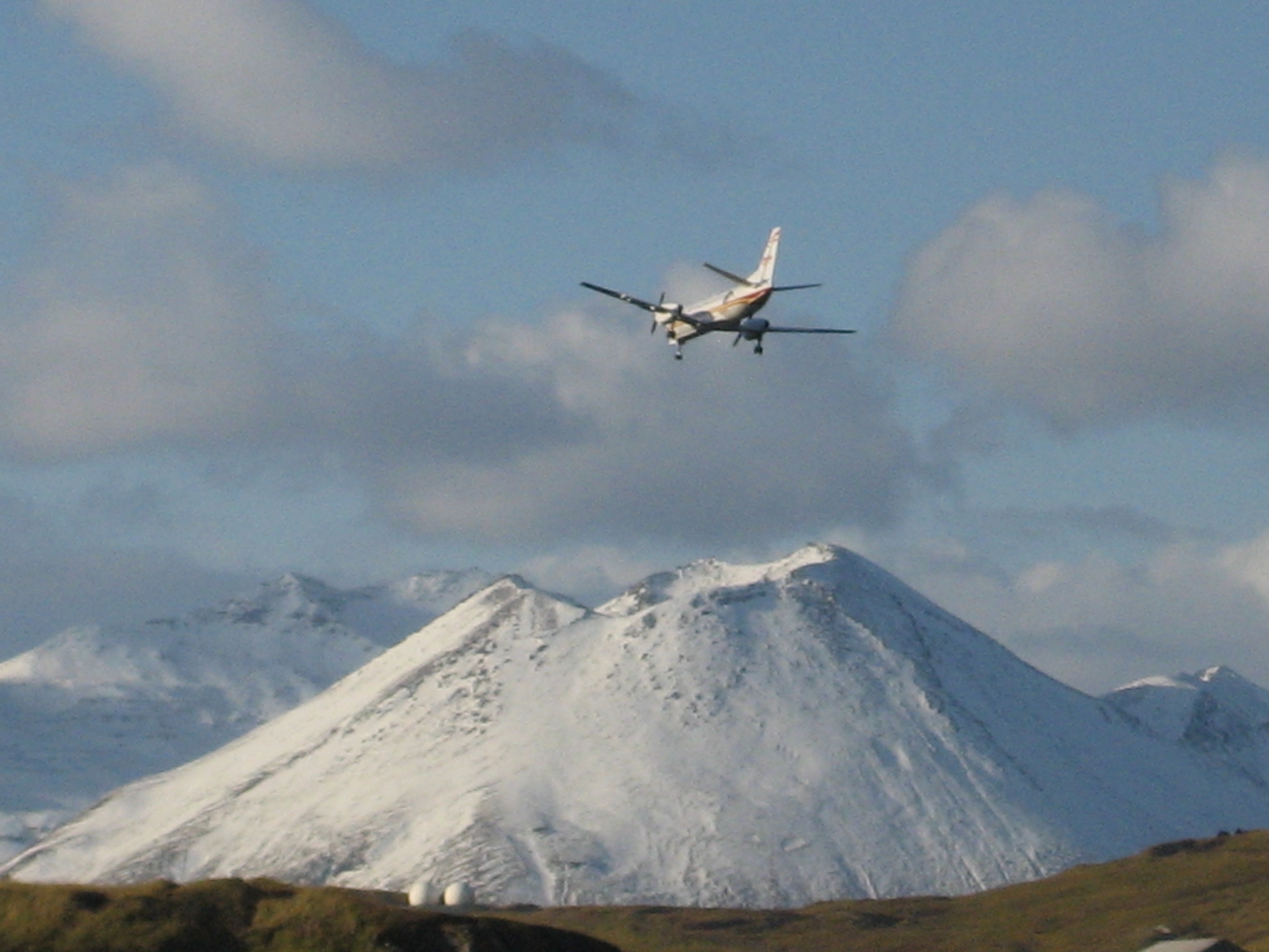 plane flying over mountain